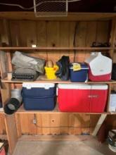 Contents of the shelf - coolers, typewriter, sleeping bags, and blankets