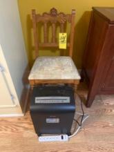 Wooden chair with paper shredder and extension cord