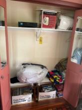 Contents of closet - board games, magazines, linens, and a VHS player