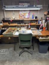 contents of desk, including phone, hand, tools, drillbits, small grinder