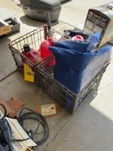 Metal crates, fuel cans, tarp