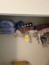 Assorted blankets, inflatable bed, and hangers