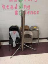 Assorted metal folding chairs and projector screen, room 1202