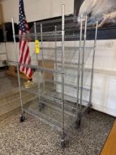Pair of metal bread racks on wheels