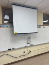 Dry erase board, roll down projector screen, book shelf, heater, Christmas lights with tree, tv -
