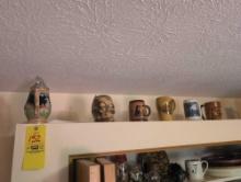 Large lot of assorted beer steins above kitchen cabinets