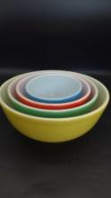 Four vintage Pyrex colored glass mixing bowls