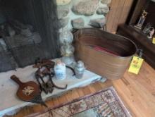 Antique copper boiler, oil lamp, ice skates, bellows, rug