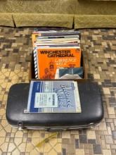 Large group of records and saxophone in case