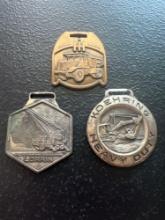 (3) Vintage Watch Fobs - Koehring Heavy Duty, International Harvester Dump Trucks, & Lorain Cranes