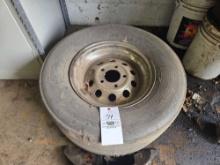 27.5x12-15 Goodyear slick on chrome rim.