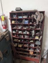 Red hardware bin with assorted hardware, u bolts, hardware, rivets, paint gun