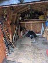 Contents of garden shed, yard tools, lumber, fuel can