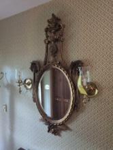 Gold framed ornate mirror with wall scounces