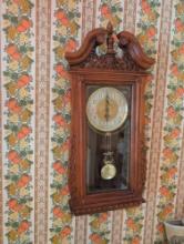 Modern wall hanging battery op clock with decorative wall hangings and plates