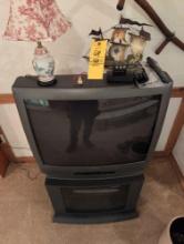 Sanyo box TV with stand and decor on top of tv