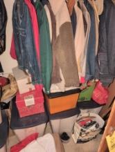 Contents of closet, totes of vintage Christmas decor, coats, fire tools