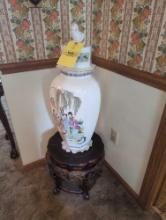Oriental urn with decorative wood base