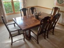Dining room table with 6 chairs and a ad in leaf