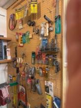 bits, hammers and hardware on pegboard wall
