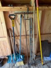Assorted tools, snow shovel, brooms, hard rakes, level, branch trimmer