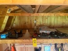 assorted contents on shelf in back of shed; shelf hardware, lamp, toilet seat, shutters, trowel