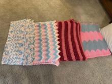 four crocheted afghans, pillows