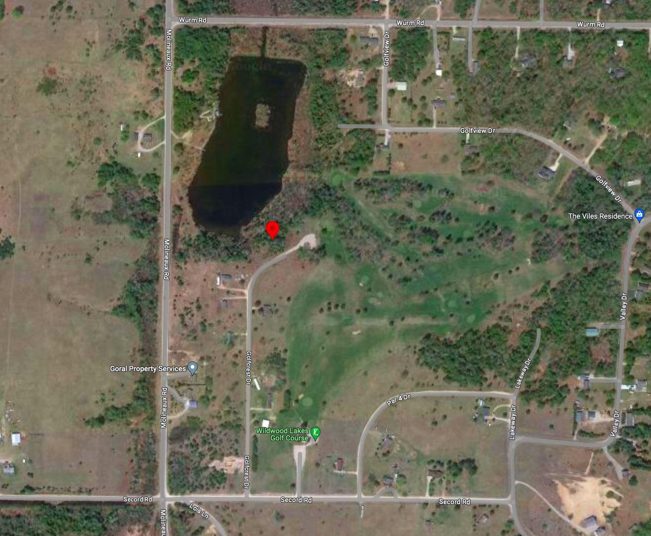 Build your Getaway Home on this 0.34 acre lot Between a Lake and a Golf Course in Cheboygan County,