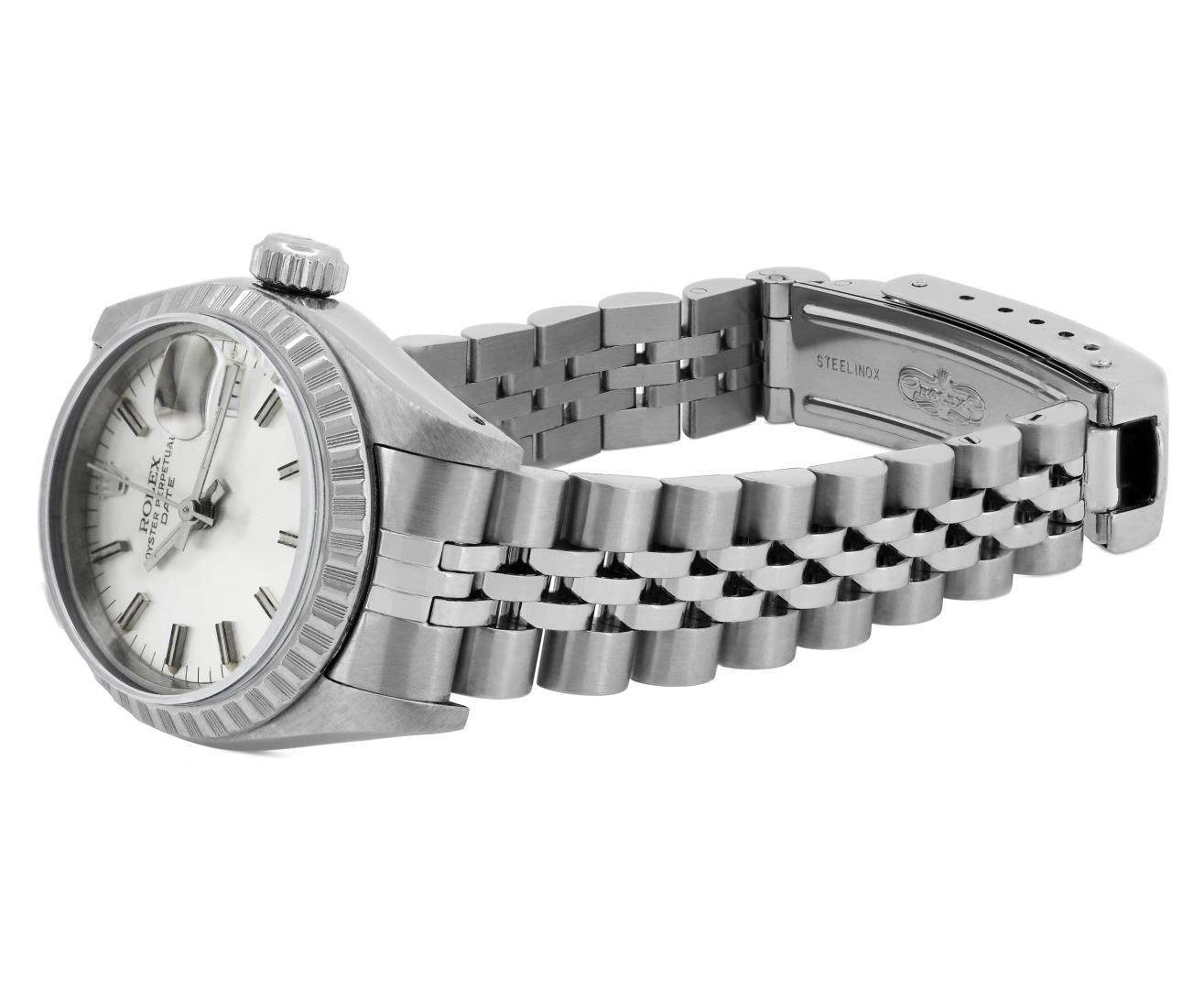 Rolex Ladies Stainless Steel Silver Index Engine Turn Bezel Date Wristwatch With