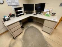 Office desk; L-shaped, steel frame, laminate top; no contents.