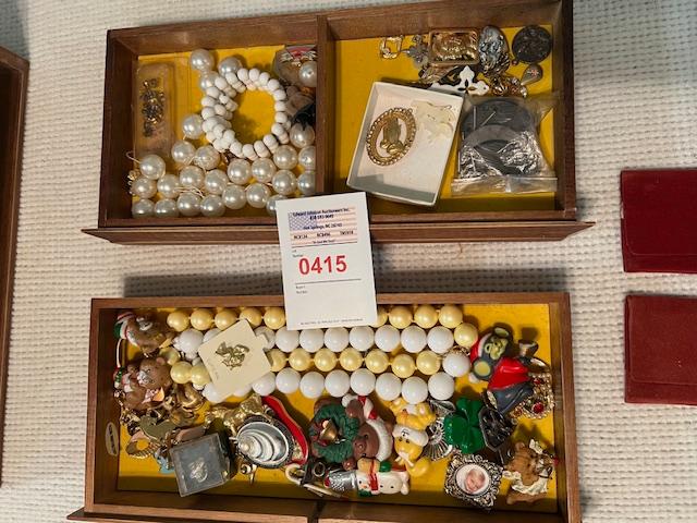 jewelry box with costume jewelry , pins and fancy gold bracelets