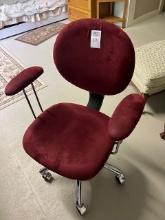 red roll around office chair