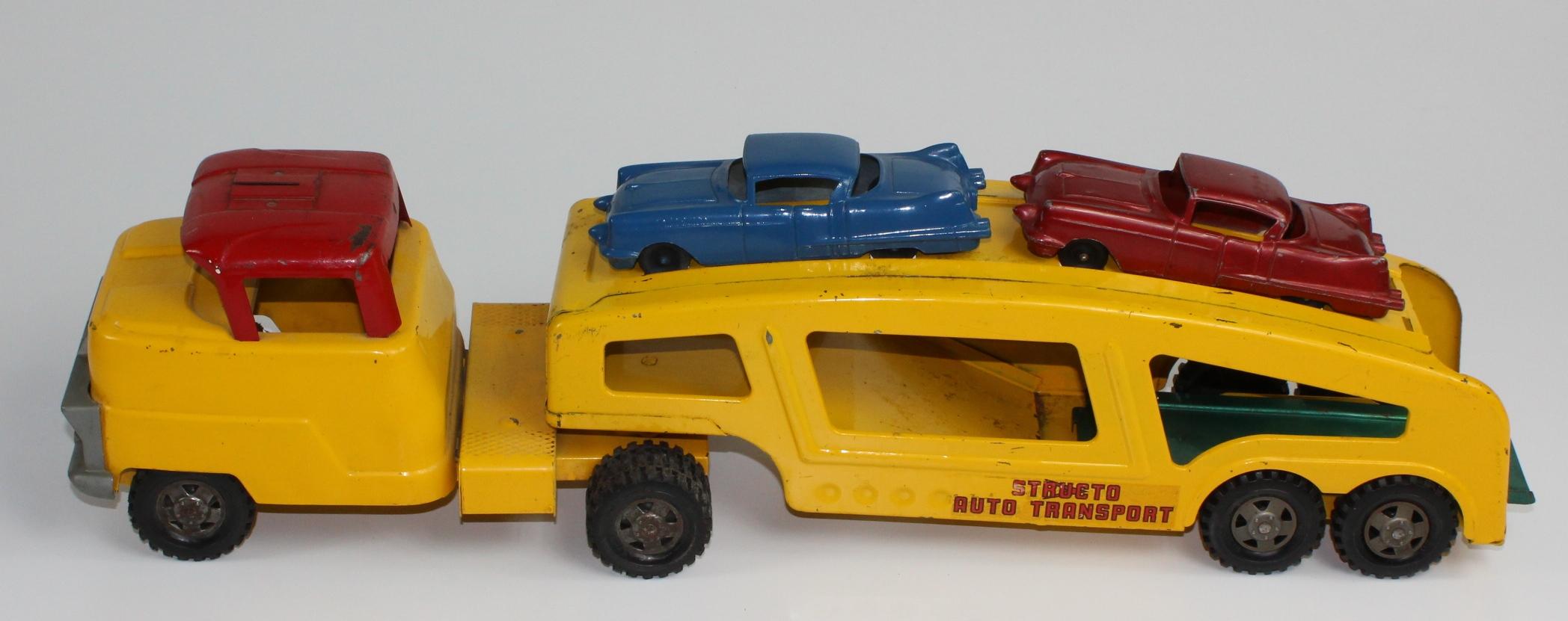 VINTAGE STRUCTO PRESSED AUTO TRANSPORT WITH 2 CARS AND RAMP