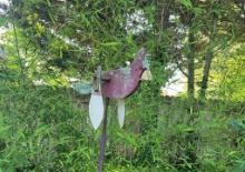 Rusty Post Holding a Whirly Gig Cardinal