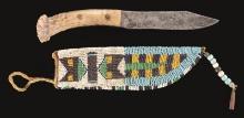 NATIVE AMERICAN KNIFE AND BEADED SHEATH.