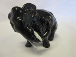 Cast iron elephant figurine with white tusks
