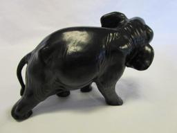 Cast iron elephant figurine with white tusks