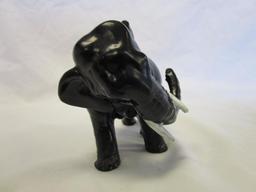 Cast iron elephant figurine with white tusks