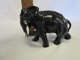 Cast iron elephant figurine with white tusks