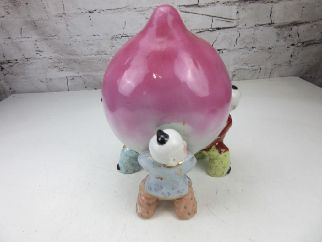 Porcelain Peach Held by Three Chinese Children