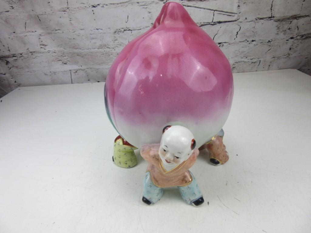 Porcelain Peach Held by Three Chinese Children