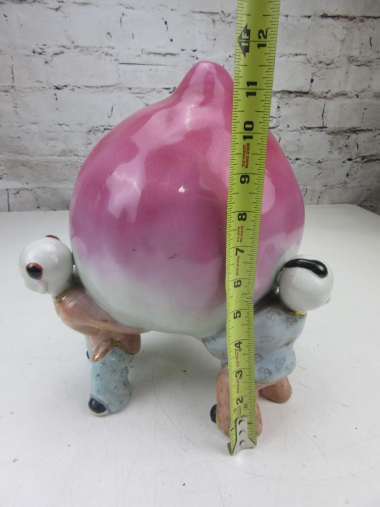 Porcelain Peach Held by Three Chinese Children