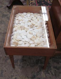 Hundreds of Sand Dollars under Glass Lamp Table