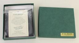 1 new Filson leather Packer wallet.