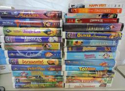 Phillips 8.5" Portable LCD DVD player with remote and 20+ Disney VHS movies.