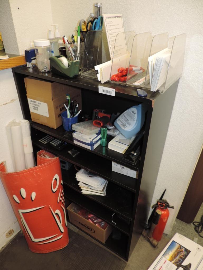 Shelving unit loaded with office supplies.