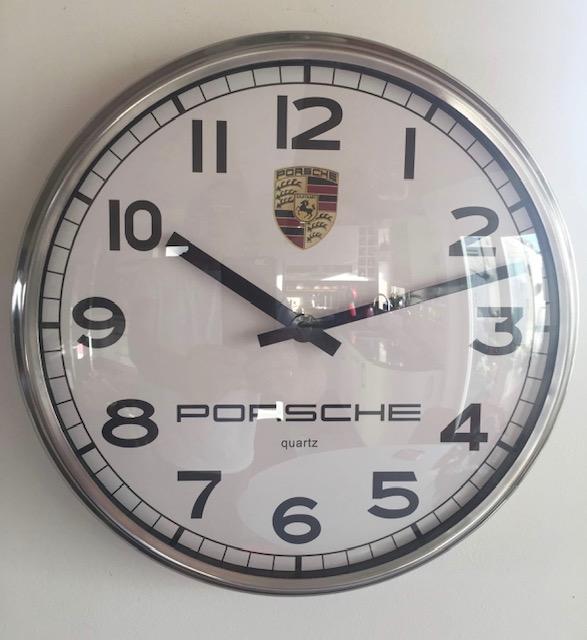 A fine circular Porsche-themed wall clock