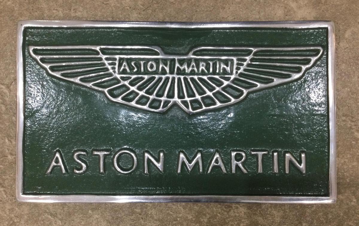 A Cast Metal Aston Martin Themed Sign with AM Wings Over