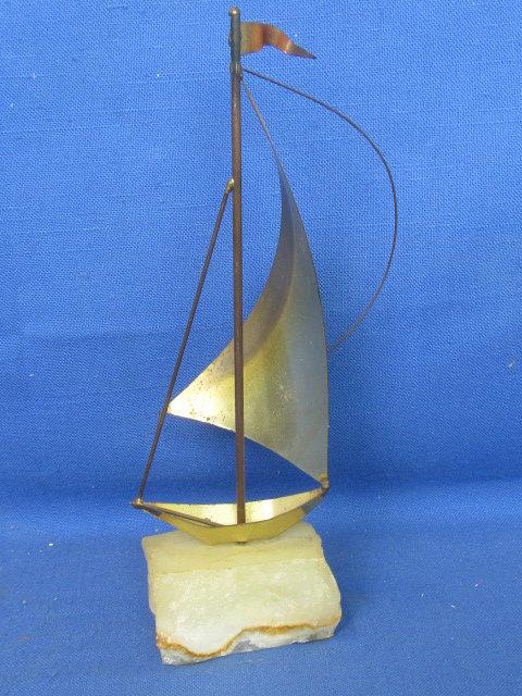 Mid Century Brutalist Brass Sailboat Sculpture on raw edge onyx base. By DeMott Signed, DeMott.