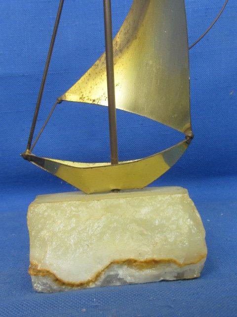 Mid Century Brutalist Brass Sailboat Sculpture on raw edge onyx base. By DeMott Signed, DeMott.